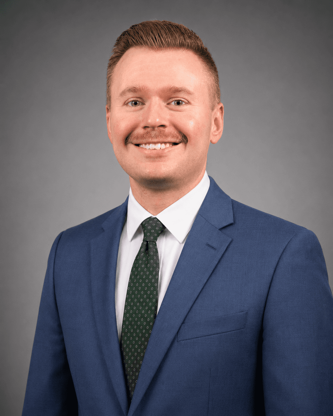 Man in blue suit with green tie.